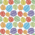 Seamless pattern with colored tropical leaves.